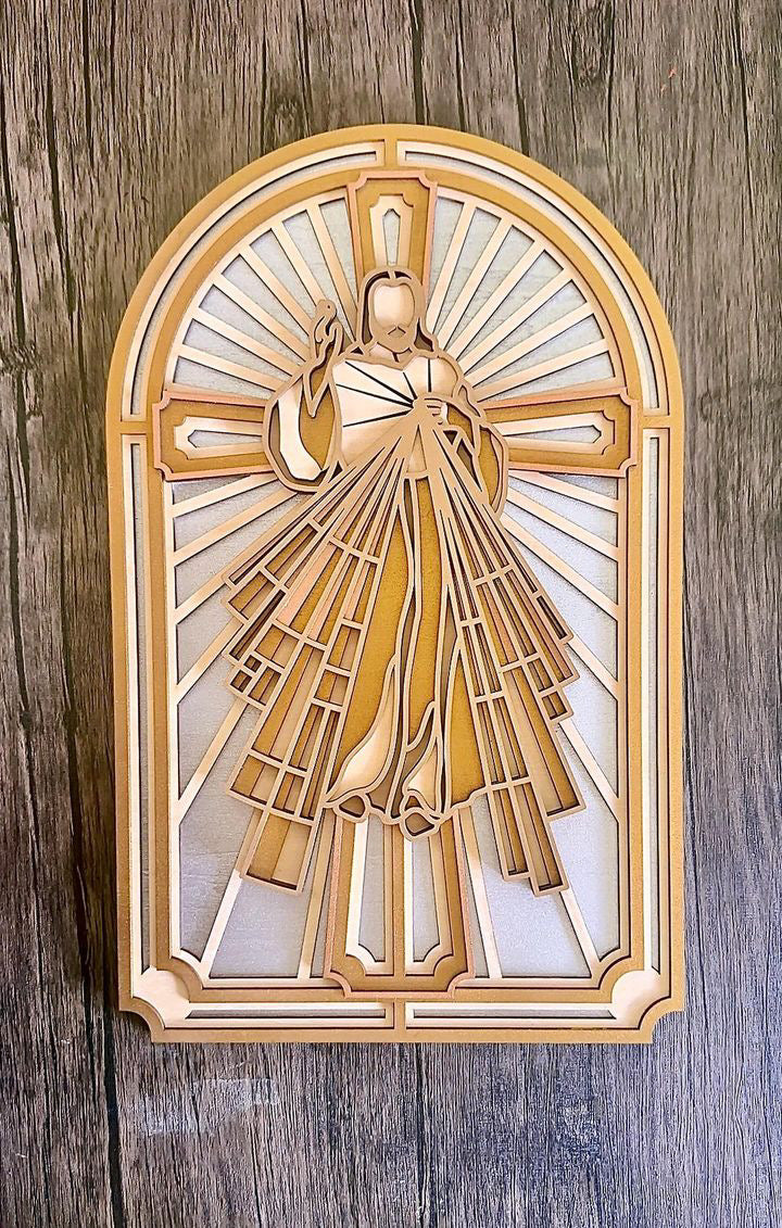 A multi-layered wood art depiction of the Sacred Heart of Jesus Christ, with a gold and white color scheme, mounted on a wooden surface.