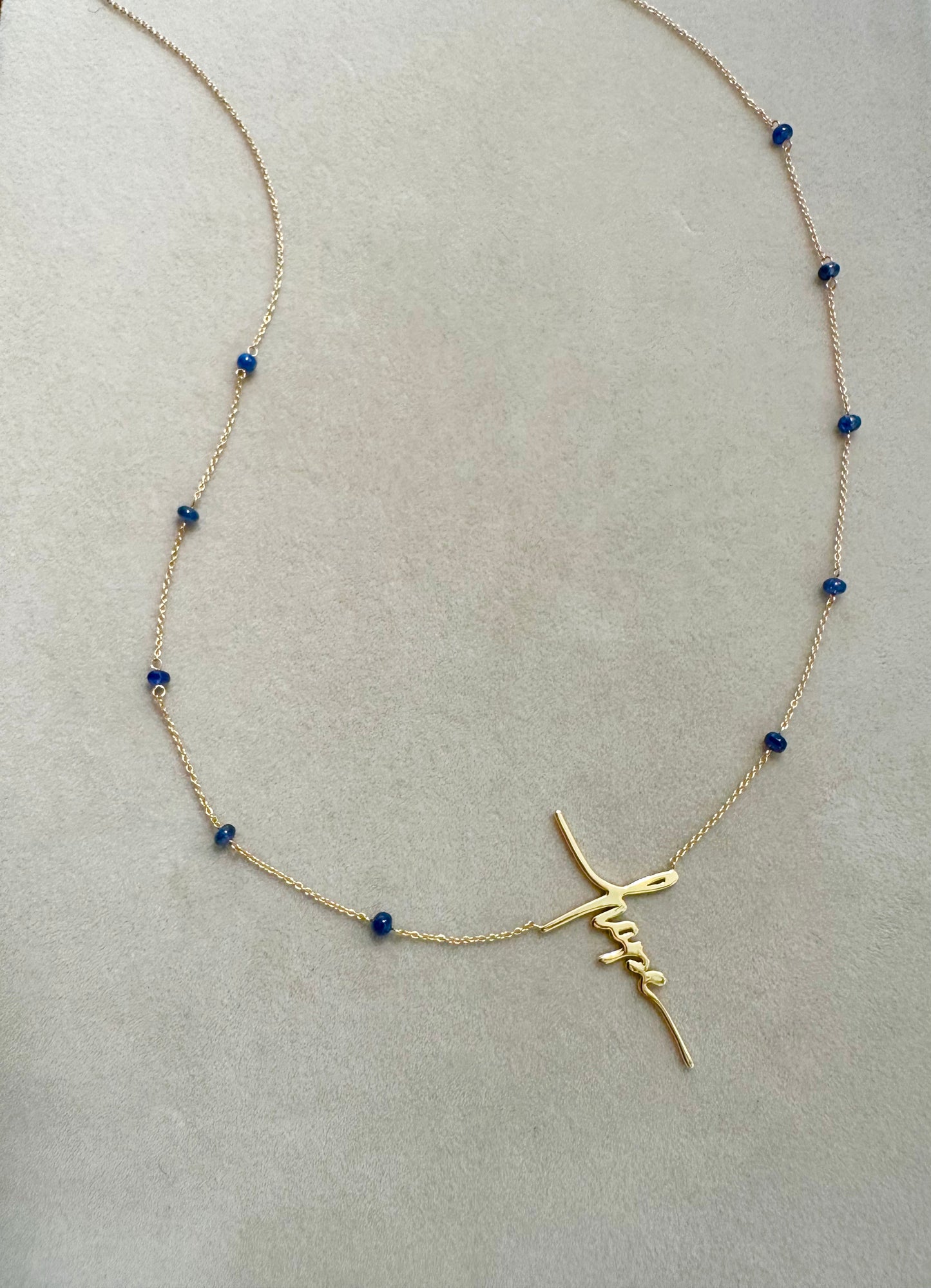 A Hope Necklace with 14K yellow gold and blue sapphires. 