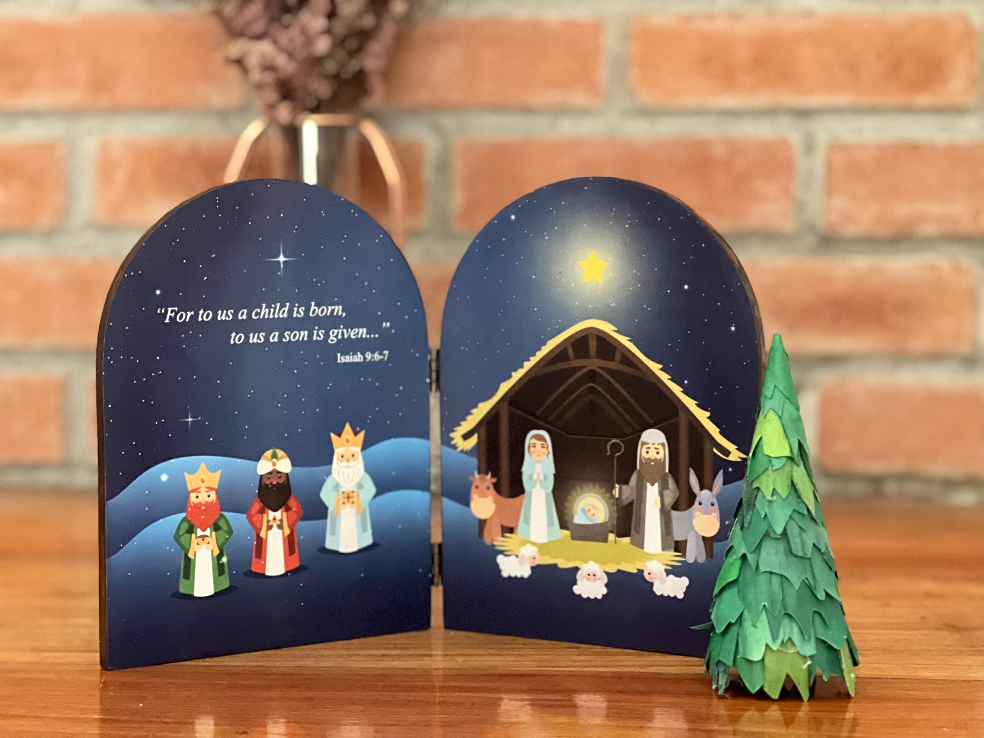 A nativity scene with a depiction of the birth of Jesus Christ, featuring figures such as Joseph, Mary, and baby Jesus in the right side and the three Wise Men in the left side, surrounded by a night sky with stars.