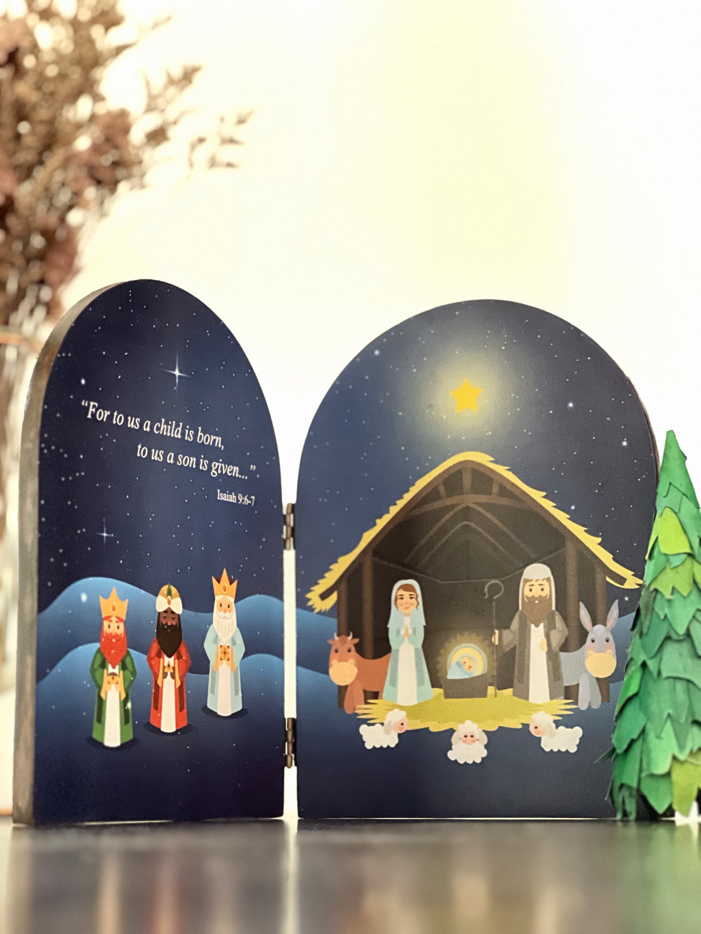 A nativity scene with a depiction of the birth of Jesus Christ, featuring figures such as Joseph, Mary, and baby Jesus in the right side and the three Wise Mens in the left side, surrounded by a night sky with stars.