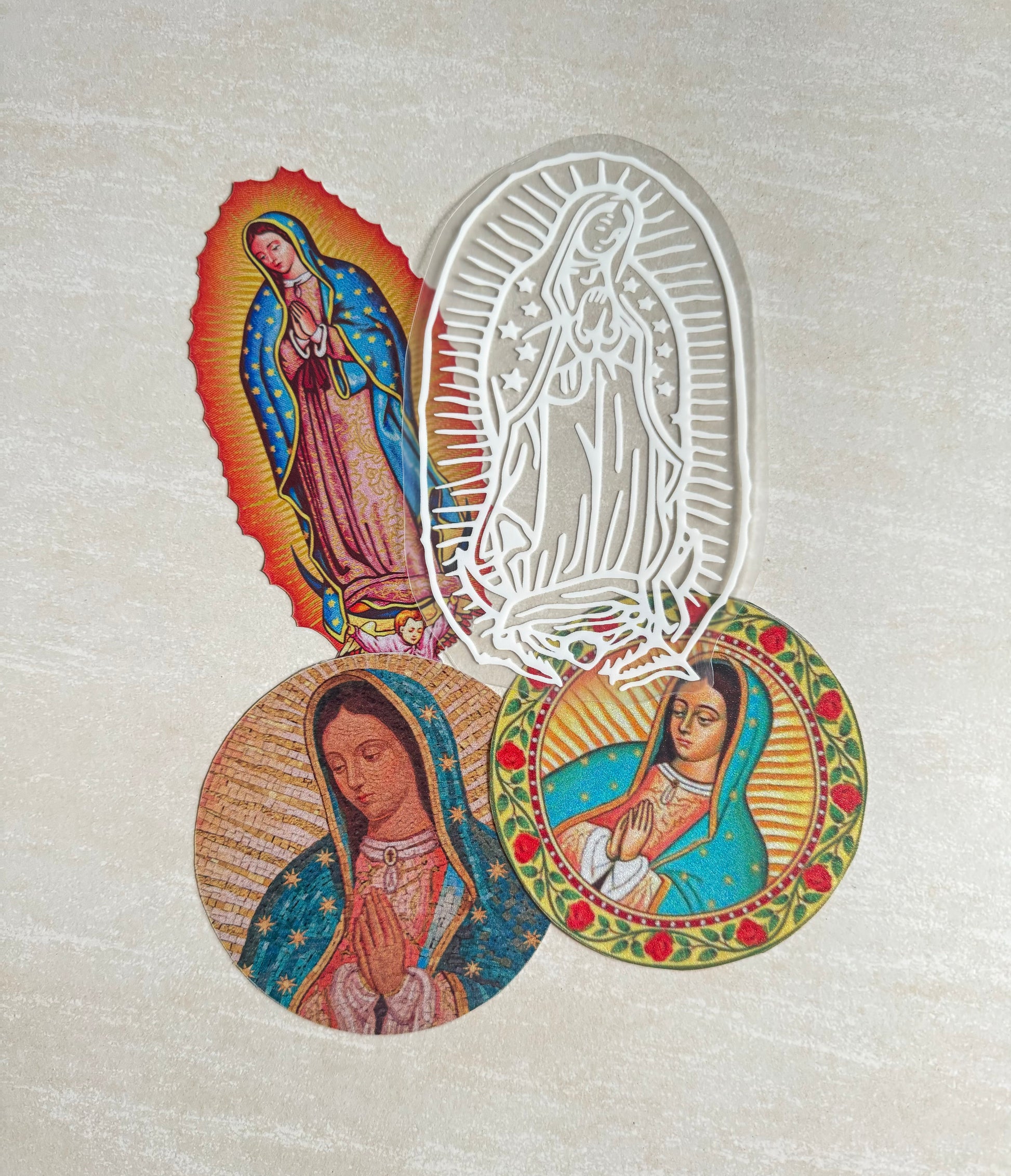 A set of four round stickers with religious themes, including an image of the Virgin Mary and a depiction of a woman in a traditional, colorful outfit.