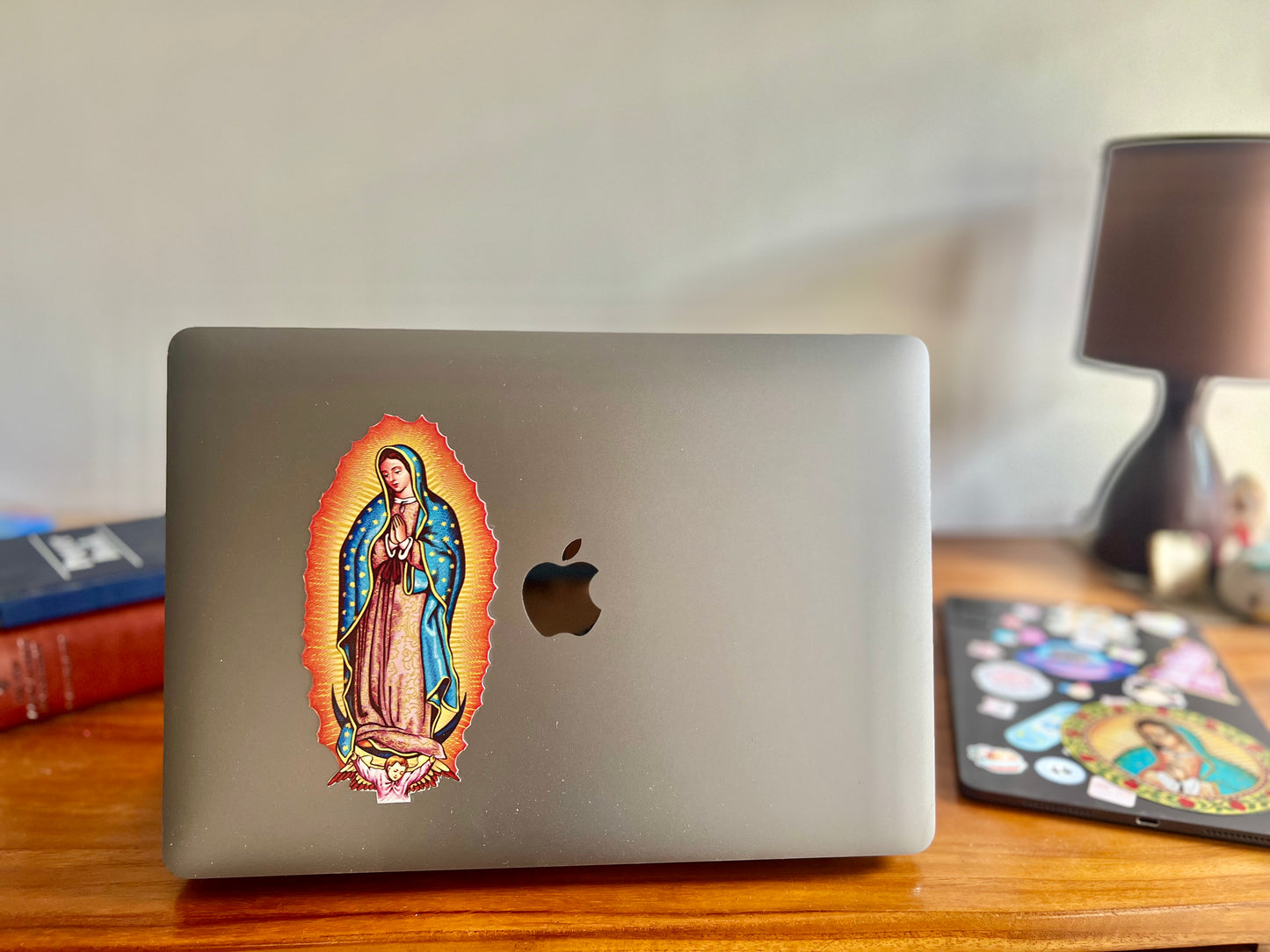 A sticker of Virgin Mary, attached at the back of Macbook