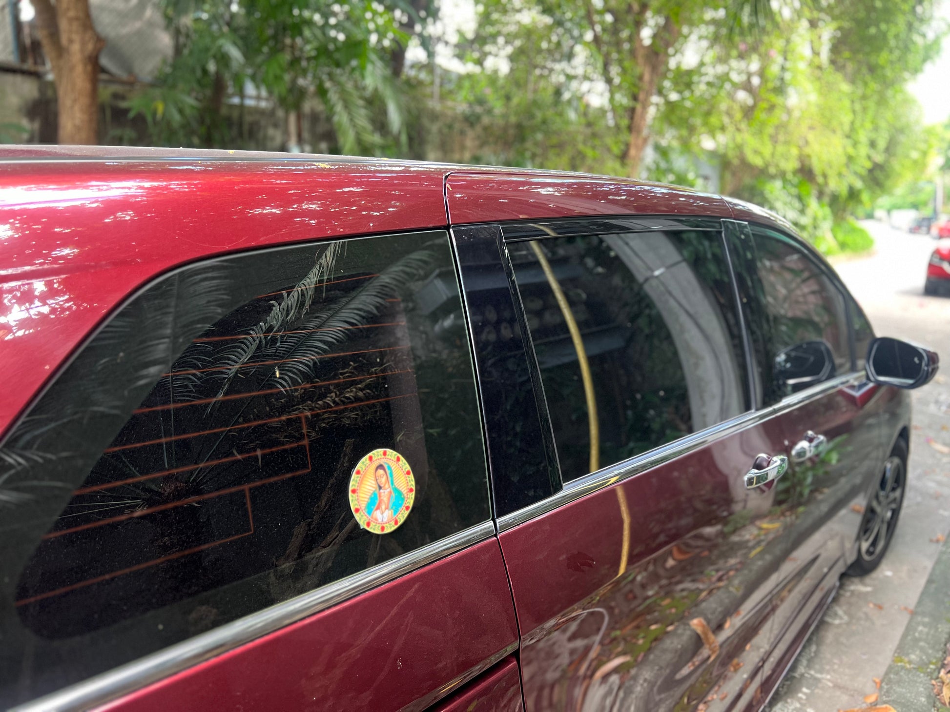 A round sticker of Virgin Mary, attached the windows car.